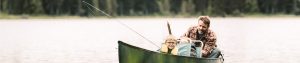 Boy fishing with Dad in boat
